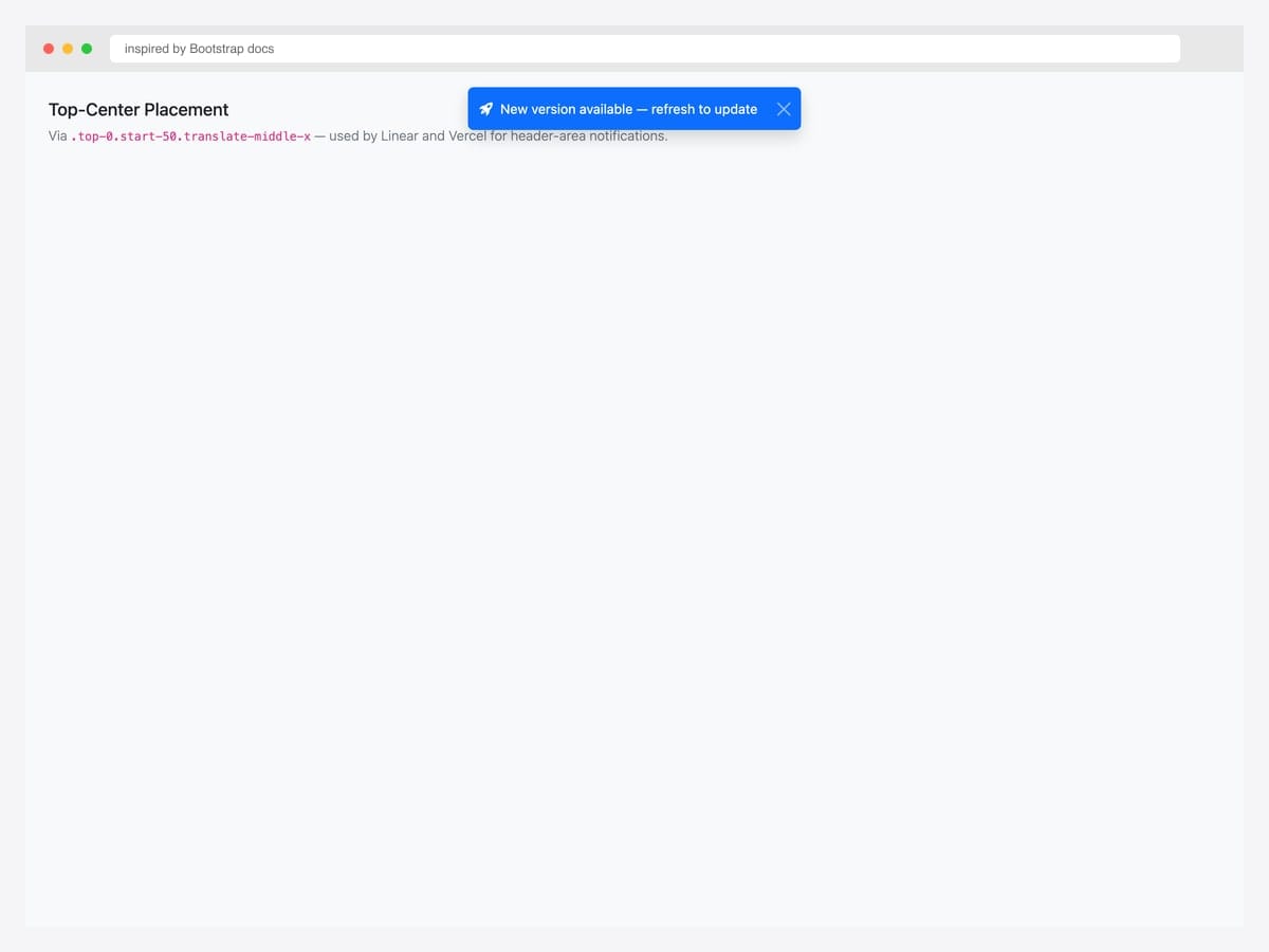Top-center placement demo — blue primary toast centered along the top edge with "New version available — refresh to update" message